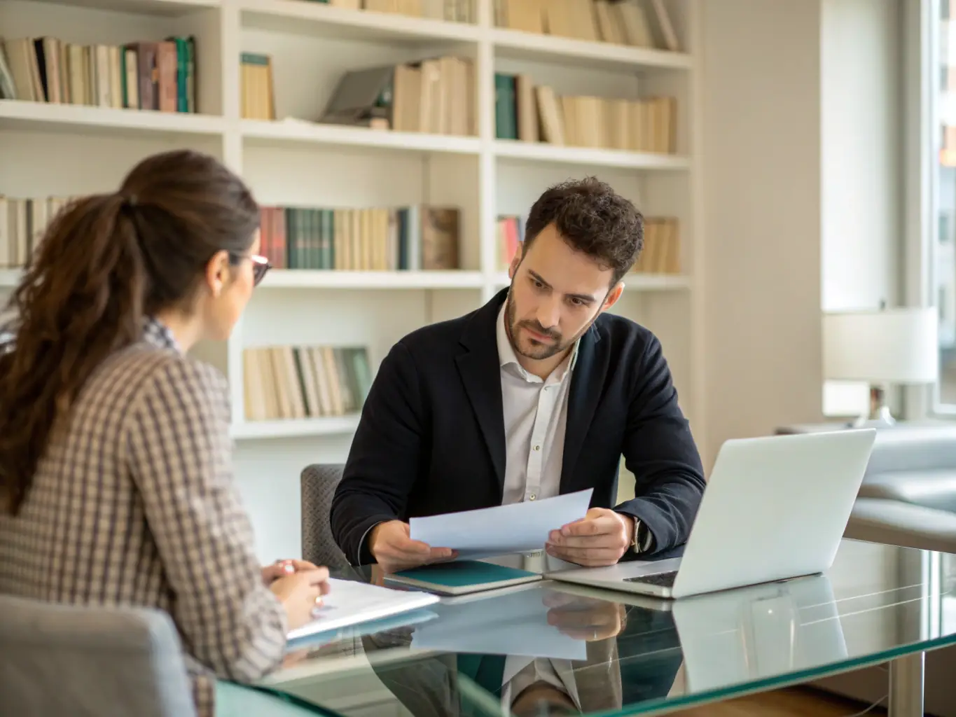 An image depicting a coach mentoring a business owner in a modern office setting, emphasizing personalized guidance and support.